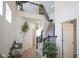 Bright foyer with staircase, plant life, and an upper level railing at 15413 Staffordshire Way, Fishers, IN 46037