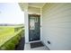 Stylish front door with glass accents, adjacent to the community lake at 15413 Staffordshire Way, Fishers, IN 46037