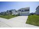Attractive two-story home featuring a three-car garage, covered porch, and well-manicured lawn at 15413 Staffordshire Way, Fishers, IN 46037