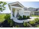 Inviting covered front porch with seating and manicured landscaping at 15413 Staffordshire Way, Fishers, IN 46037