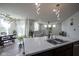 Bright, open-concept living room with large windows, modern lighting, and cozy decor at 15413 Staffordshire Way, Fishers, IN 46037