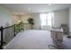 Upstairs loft area with plush carpeting, hanging lights and a comfortable rocking chair at 15413 Staffordshire Way, Fishers, IN 46037