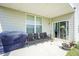 Covered patio with outdoor seating area including grill and adjacent lawn at 15413 Staffordshire Way, Fishers, IN 46037