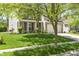 Beautiful home exterior featuring lush green lawn and mature trees, offering a serene setting at 16001 Concert Way, Noblesville, IN 46060