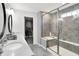 This bathroom has a double vanity, decorative mirrors, and tiled shower with glass enclosure at 16516 Wilsons Farm Dr, Fishers, IN 46040