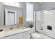 Bright bathroom with a modern vanity, quartz countertop, bathtub, shower with glass enclosure, and neutral color palette at 16516 Wilsons Farm Dr, Fishers, IN 46040