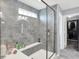 Beautiful walk-in shower with gray tile and a built-in bench at 16516 Wilsons Farm Dr, Fishers, IN 46040
