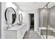 This bathroom has a double vanity, decorative mirrors, and tiled shower with glass enclosure at 16516 Wilsons Farm Dr, Fishers, IN 46040