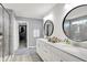 Modern bathroom featuring a double sink vanity, walk-in shower and large mirrors at 16516 Wilsons Farm Dr, Fishers, IN 46040