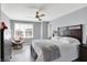 Comfortable bedroom with a ceiling fan, hardwood floors and plenty of natural light at 16516 Wilsons Farm Dr, Fishers, IN 46040