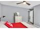 This bedroom has a ceiling fan, dresser, and neutral colored walls at 16516 Wilsons Farm Dr, Fishers, IN 46040