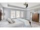 Inviting bedroom with natural light, large windows, a comfortable bed, wood dresser, and a neutral color palette at 16516 Wilsons Farm Dr, Fishers, IN 46040