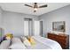 Comfortable bedroom featuring a queen-sized bed, ceiling fan, dresser, closet doors, and neutral color palette at 16516 Wilsons Farm Dr, Fishers, IN 46040