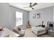 This bedroom features a ceiling fan, chair, and natural light at 16516 Wilsons Farm Dr, Fishers, IN 46040