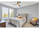 Inviting bedroom with natural light, a comfortable queen-sized bed, ceiling fan, and chair at 16516 Wilsons Farm Dr, Fishers, IN 46040