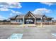 Community clubhouse entrance featuring accessible parking and well-maintained landscaping at 16516 Wilsons Farm Dr, Fishers, IN 46040