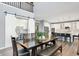 Dining room with a dark wood table and bench, adjacent to the kitchen and featuring a barn door at 16516 Wilsons Farm Dr, Fishers, IN 46040