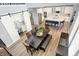 Open-concept dining area with dark wood table, bench seating, and views of the kitchen and adjacent spaces at 16516 Wilsons Farm Dr, Fishers, IN 46040