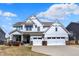 Charming two-story home boasts a manicured lawn, a welcoming porch, and a convenient two-car garage, ideal for Gathering living at 16516 Wilsons Farm Dr, Fishers, IN 46040