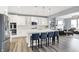 Spacious kitchen with white cabinets, a large island with seating, and stainless steel appliances, perfect for entertaining at 16516 Wilsons Farm Dr, Fishers, IN 46040