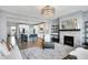 Inviting living room with fireplace, modern light fixture, stylish seating, and open view to the kitchen at 16516 Wilsons Farm Dr, Fishers, IN 46040