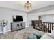 Open living room boasts neutral colors, plush rug, and second-story view at 16516 Wilsons Farm Dr, Fishers, IN 46040