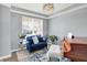 Bright living room with plush blue sofa, decorative pillows, wood floors and a modern chandelier, perfect for relaxation at 16516 Wilsons Farm Dr, Fishers, IN 46040