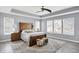 This spacious main bedroom features a tray ceiling, ceiling fan, and wood flooring at 16516 Wilsons Farm Dr, Fishers, IN 46040