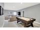 Spacious recreation room features an air hockey table, comfortable seating, and neutral decor at 16516 Wilsons Farm Dr, Fishers, IN 46040