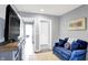 Cozy sitting area with blue velvet sofa, hardwood floors, and plenty of natural light at 16516 Wilsons Farm Dr, Fishers, IN 46040