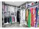 Spacious walk-in closet with custom shelving and lots of clothing at 16516 Wilsons Farm Dr, Fishers, IN 46040