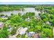 Aerial view of a lakeside community featuring tree-lined streets and waterfront properties at 169 Bayview Dr, Cicero, IN 46034