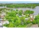 Aerial view showcasing houses near a lake surrounded by lush green trees and open land at 169 Bayview Dr, Cicero, IN 46034