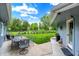 A large patio area with table seating offers a lovely backyard view surrounded by mature trees and greenery at 169 Bayview Dr, Cicero, IN 46034