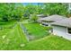 The grassy fenced backyard features a home's neutral exterior at 169 Bayview Dr, Cicero, IN 46034
