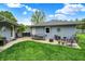Well-maintained backyard with a patio dining set, seating area, lush lawn, and serene greenery at 169 Bayview Dr, Cicero, IN 46034
