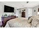 Bedroom with a TV, dresser, throw pillows and blanket, and white doors at 169 Bayview Dr, Cicero, IN 46034