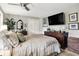 Bedroom with a TV, dark wood dresser, throw pillows and blanket, ceiling fan, and white bi-fold doors at 169 Bayview Dr, Cicero, IN 46034