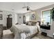 Bright bedroom featuring a bed with throw pillows and blanket, side tables and lamps, and a dark wood dresser at 169 Bayview Dr, Cicero, IN 46034