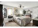 Neutral bedroom featuring a bed with throw pillows and blanket, side tables and lamps, and a ceiling fan at 169 Bayview Dr, Cicero, IN 46034