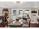 Inviting dining room with modern chandelier, a glass table, and access to outdoor views through windows at 169 Bayview Dr, Cicero, IN 46034