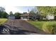Charming home featuring a stone facade, flag pole, and a detached two car garage at 169 Bayview Dr, Cicero, IN 46034