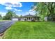 Scenic view of a well-kept ranch house with green lawn and a detached garage, under a bright sky at 169 Bayview Dr, Cicero, IN 46034