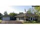 Charming home featuring a stone facade, flag pole, and a detached two car garage at 169 Bayview Dr, Cicero, IN 46034
