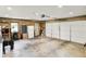 Spacious garage with a white door, wood paneling, ample storage space, and a utility door at 169 Bayview Dr, Cicero, IN 46034