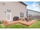 Backyard featuring a wooden deck with outdoor seating and BBQ, surrounded by a green lawn at 1815 Kingen Dr, Greenfield, IN 46140