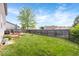 Spacious backyard features a deck with outdoor seating, well-maintained lawn, and a privacy fence at 1815 Kingen Dr, Greenfield, IN 46140