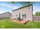 Backyard features a deck with seating, a fire pit, a lush green lawn, and a wood fence at 1815 Kingen Dr, Greenfield, IN 46140