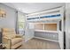bedroom features a bunk bed, chair, large window with natural light, and neutral decor at 1815 Kingen Dr, Greenfield, IN 46140