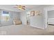 Spacious bedroom with neutral carpet, a cozy couch, and doorways leading to other rooms in the house at 1815 Kingen Dr, Greenfield, IN 46140